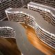 man standing inside library while reading book